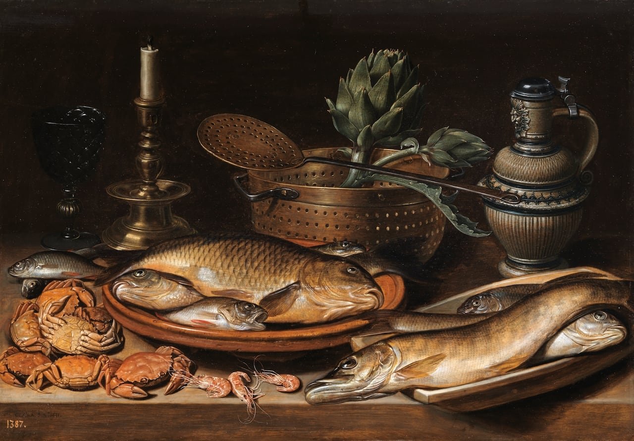 a still life painting showing fish, crabs, prawns, candles, artichokes and a jug